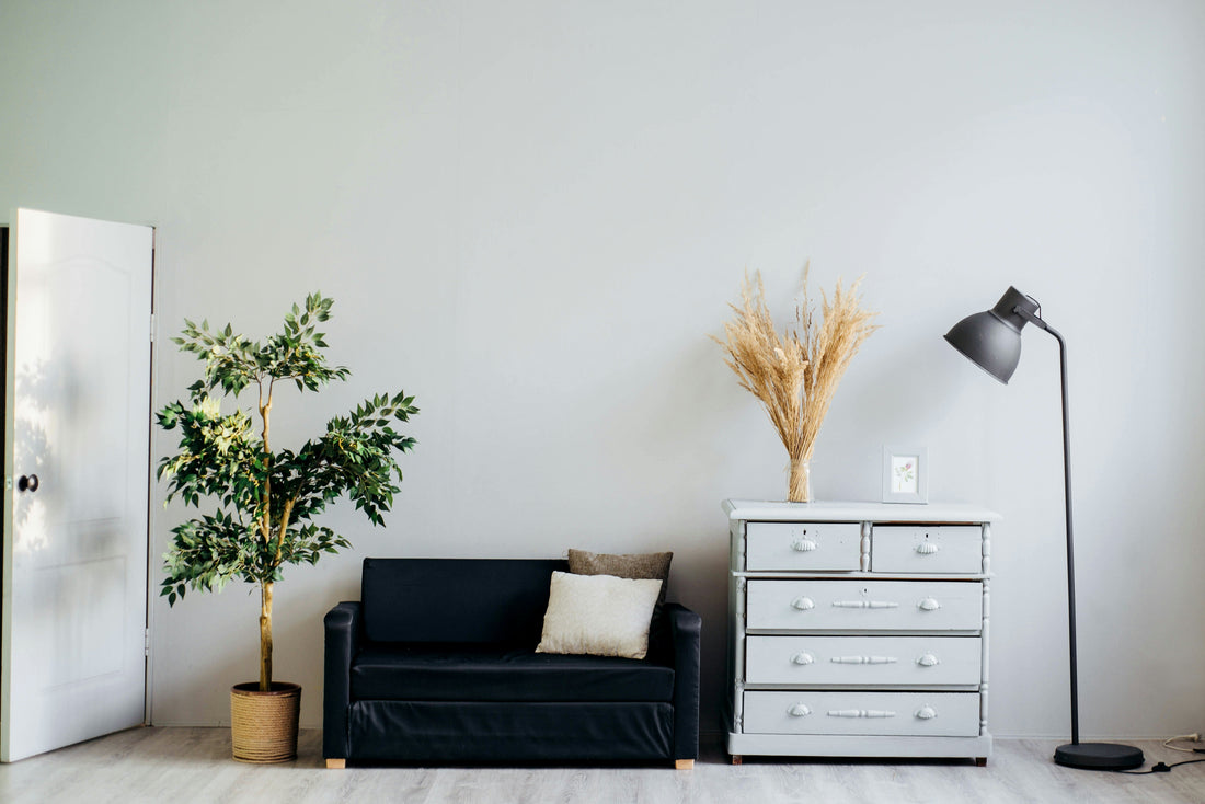 Sleek cabinet knobs styled on a white dresser in a minimalist Japandi living room by HomeTouch.