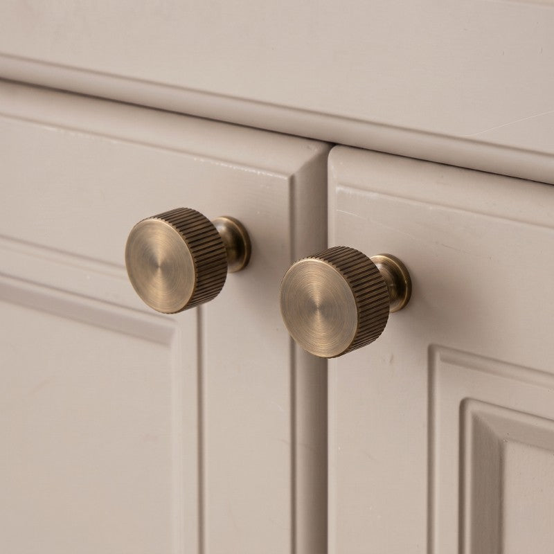 Hometouch's curved cabinet handle in antique gold brass finish is presented in a clean product shot ideal for furniture hardware specification and retail display contexts.