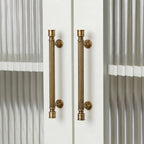 Hometouch's warm yellow oval brass cabinet handle is presented in a clean product photograph ideal for furniture hardware specifications and modern kitchen renovation visualizations.