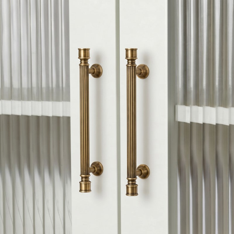 Hometouch's warm yellow oval brass cabinet handle is presented in a clean product photograph ideal for furniture hardware specifications and modern kitchen renovation visualizations.