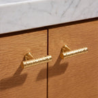 A golden brass cabinet pull from Hometouch's hardware collection features a polished bar-shaped design suitable for contemporary kitchen cabinetry and furniture applications.