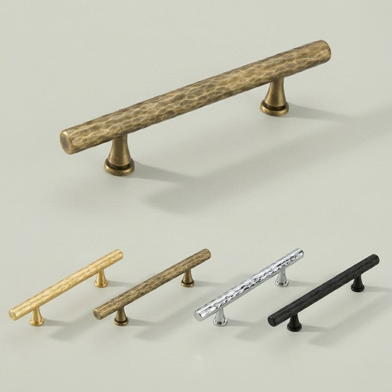 A minimalist cylindrical cabinet pull handle photographed in brass, antique bronze, silver, and matte black finishes under consistent studio lighting for furniture hardware product catalogs and e-commerce applications.