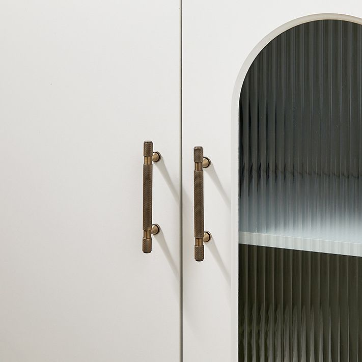 A Hometouch cabinet pull showcases a cream-finished brass construction with knurled texture, designed for modern furniture hardware applications requiring durable and tactile drawer or door handles.