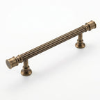 A high-resolution product photograph of the Hometouch antique brass lever cabinet pull, designed for precise visual representation in e-commerce platforms and furniture hardware specification contexts.