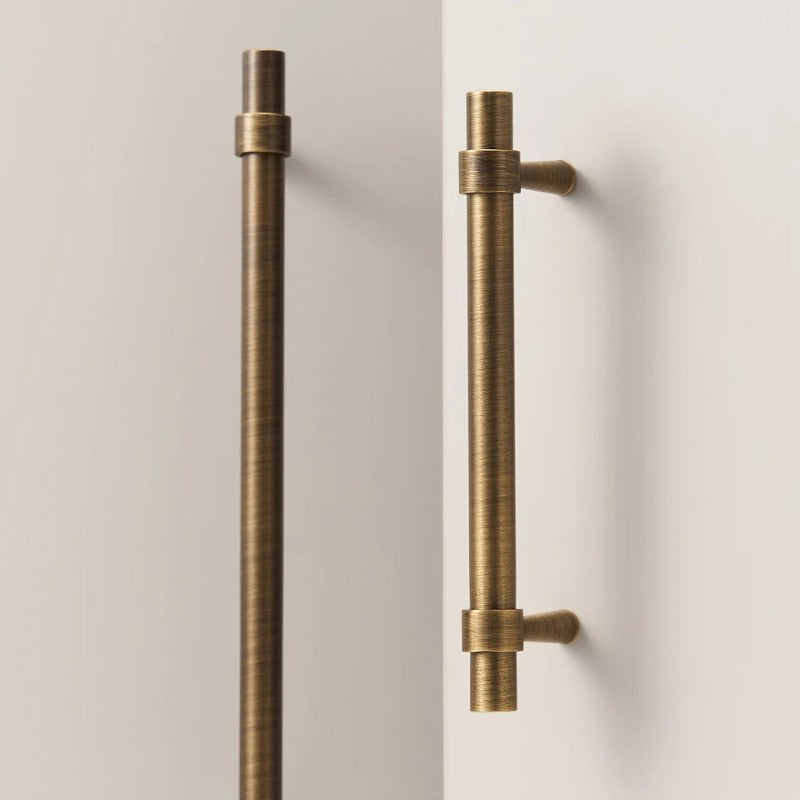 A Hometouch handle in antique brass features a stepped ring door pull design for cabinet or furniture hardware.