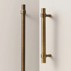 A Hometouch handle in antique brass features a stepped ring door pull design for cabinet or furniture hardware.