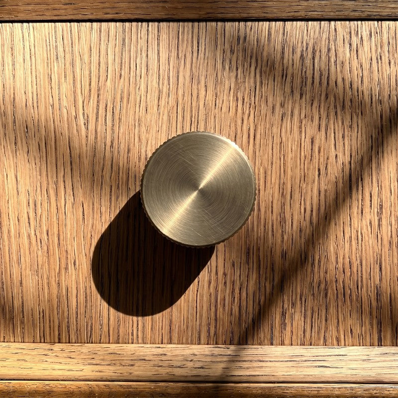An antique brass finished T-bar cabinet handle from Hometouch's hardware line, photographed as a clean isolated product shot against white background for use in furniture design and cabinetry applications.