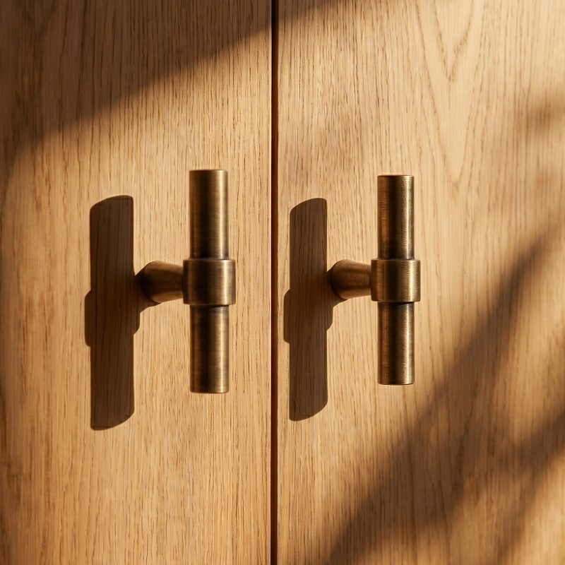 A clean product shot of the Hometouch brass-finished D-pull cabinet handle isolated on a neutral background, designed for use in hardware specifications or e-commerce product displays.