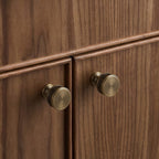 Brass rectangular cabinet knobs by Hometouch, installed on warm walnut wood doors, embodying modern minimalist and Japandi aesthetic with clean lines and textured finish.