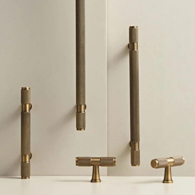 Hometouch's T-shaped kitchen cabinet pull showcases a gold-toned brass finish ideal for modern cabinetry hardware applications.