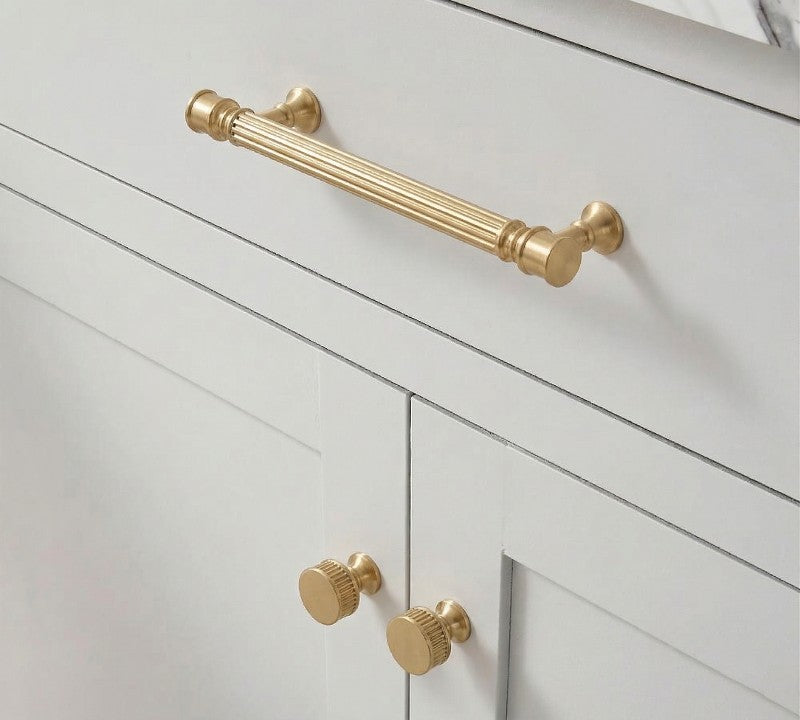 A teardrop-shaped cabinet pull in brass gold finish, designed for furniture and cabinetry hardware with a product page available at www.hometouchware.com.