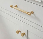 A teardrop-shaped cabinet pull in brass gold finish, designed for furniture and cabinetry hardware with a product page available at www.hometouchware.com.