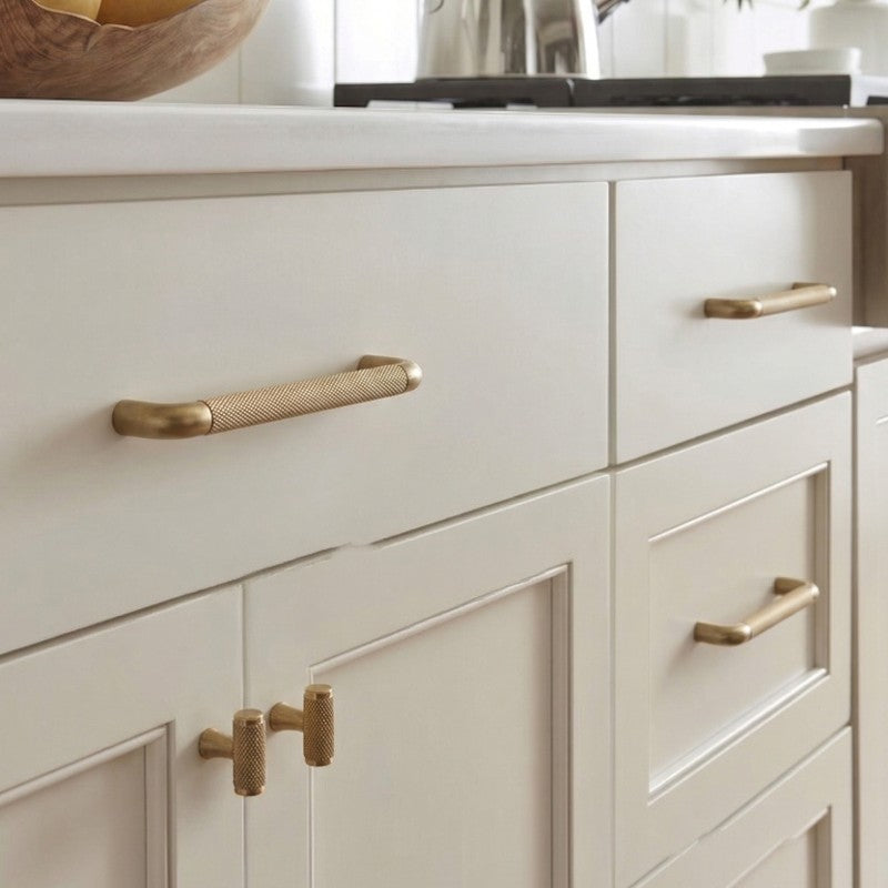 A teardrop-shaped cabinet pull in brass gold finish, designed for furniture hardware with a product URL linking to hometouchware.com.