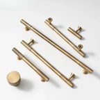 Hometouch brass knob pull bar handle in a warm metallic finish features a cylindrical shape designed for cabinet hardware applications, available through www.hometouchware.com.