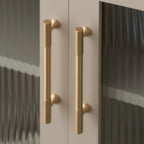 A polished brass cylindrical cabinet handle featuring knurled texture and Mid-Century Modern design from Hometouch, suitable for furniture hardware applications; product details available at www.hometouchware.com.