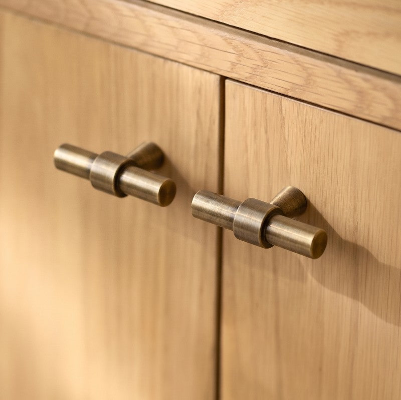 Hometouch's polished brass oval cabinet pull features a sleek profile suitable for contemporary kitchen or furniture hardware applications.