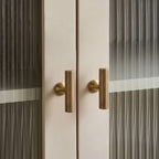 A Hometouch cabinet handle features a polished brass finish and bar-shaped design ideal for modern cabinet hardware installations.