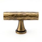 A Hometouch oval cabinet pull features polished brass construction with an antique gold finish. The isolated product image serves as professional reference for furniture hardware specification and cabinetry design.