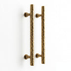 A product image of a Hometouch brass gold finish curved cabinet pull handle on a white background, showcasing the metallic luster and ergonomic shape for e-commerce use on hometouchware.com.