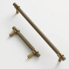 A brass knurled cabinet pull from Hometouch featuring a textured grip surface and functional design for furniture hardware applications, available through www.hometouchware.com.