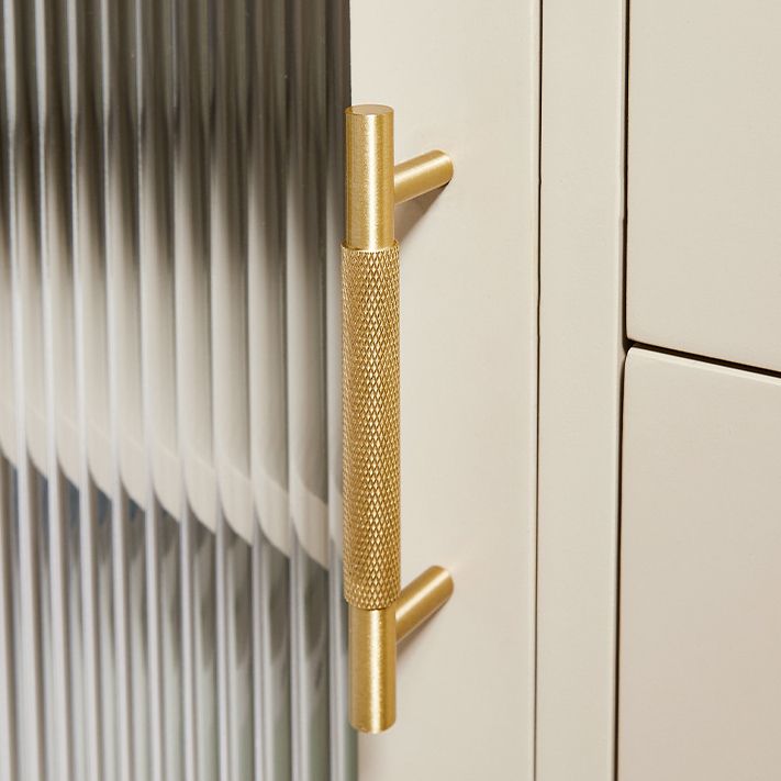 A minimalist brass cabinet pull from Hometouch features a knurled net pattern texture for modern furniture hardware applications, available at www.hometouchware.com.