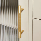 A minimalist brass cabinet pull from Hometouch features a knurled net pattern texture for modern furniture hardware applications, available at www.hometouchware.com.