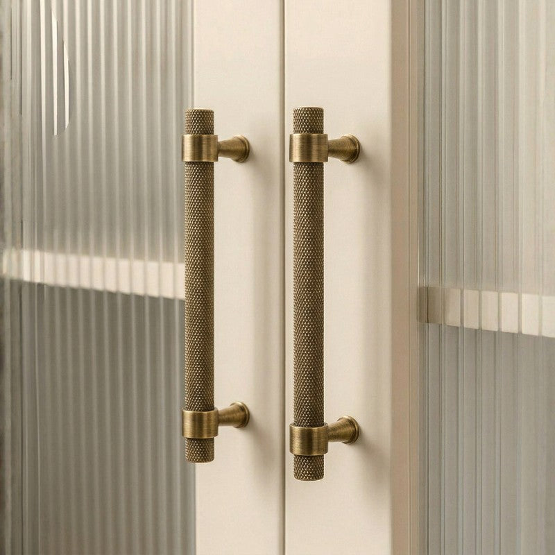 Hometouch antique brass bar cabinet pull features a bar-style shape in warm antique brass finish, presented as product photography for hardware specifications and available through www.hometouchware.com.
