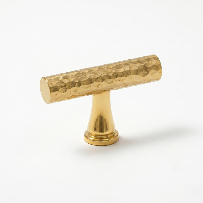A Hometouch-branded antique brass cabinet pull features a slim horizontal bar profile with a warm aged finish, designed for modern kitchen or bathroom cabinetry hardware applications requiring durable and timeless metallic accents.
