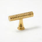 A Hometouch-branded antique brass cabinet pull features a slim horizontal bar profile with a warm aged finish, designed for modern kitchen or bathroom cabinetry hardware applications requiring durable and timeless metallic accents.