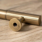 An antique brass-finished oval cabinet pull bar from Hometouch's hardware collection, presented in clean product photography for use in furniture design specifications and e-commerce contexts; source details available at www.hometouchware.com.