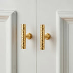 A Hometouch-branded antique brass curved bar cabinet pull displayed in isolation to clearly showcase its vintage finish and ergonomic curved profile for kitchen or furniture hardware design applications.