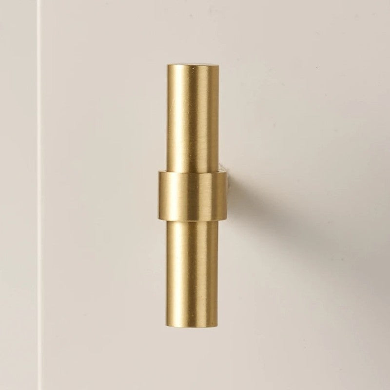 A brass T-bar cabinet pull in a gold finish, designed for furniture and cabinetry hardware applications, with product details available at hometouchware.com.