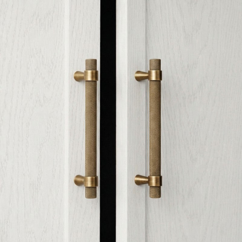A curved golden brass cabinet pull handle from Hometouch, designed for modern furniture hardware applications, available at www.hometouchware.com.