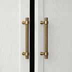A curved golden brass cabinet pull handle from Hometouch, designed for modern furniture hardware applications, available at www.hometouchware.com.