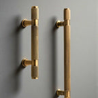 Hometouch's knurled brass T-bar cabinet pull features a textured grip surface and clean geometric lines designed for modern cabinetry and furniture hardware applications.