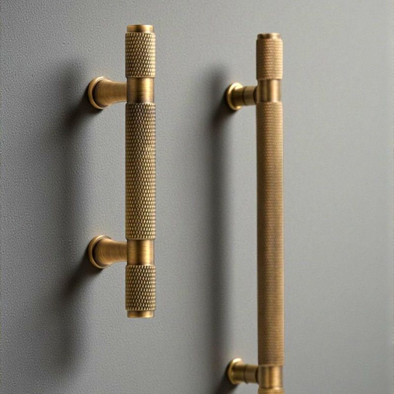 Hometouch's knurled brass T-bar cabinet pull features a textured grip surface and clean geometric lines designed for modern cabinetry and furniture hardware applications.