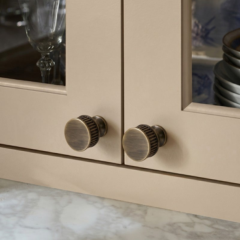 Textured minimalist cabinet knobs in antique style, sleek and elegant for modern European kitchen cabinetry by HomeTouch.