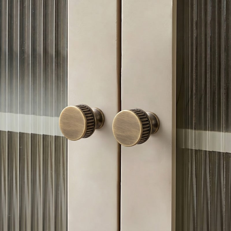 Textured minimalist cabinet knobs in Japandi style, sleek matte finish on white cabinetry by HomeTouch.