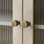 Textured minimalist cabinet knobs in Japandi style, sleek matte finish on white cabinetry by HomeTouch.