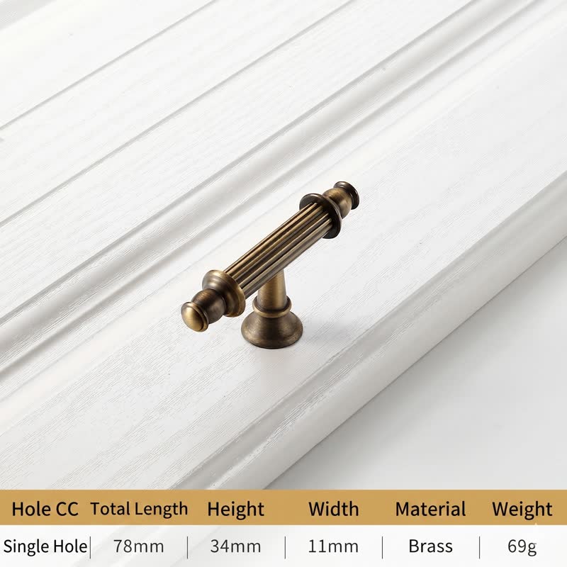 A textured, ribbed brass cabinet pull with a sleek elongated design, ideal for modern European-style cabinetry—by HomeTouch.